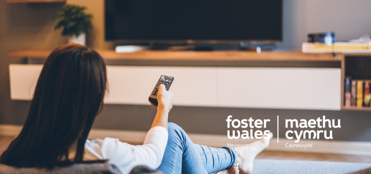 foster wales hero image of a young woman sat turning the tv on