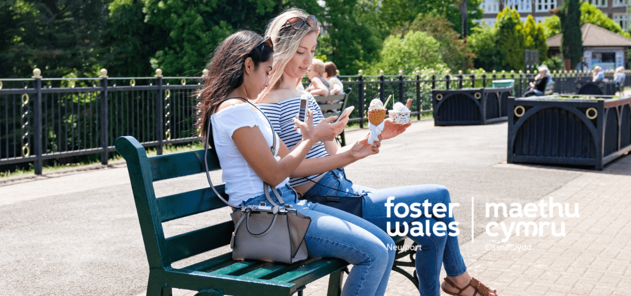 hero image of two young women eating ice cream and using their phone