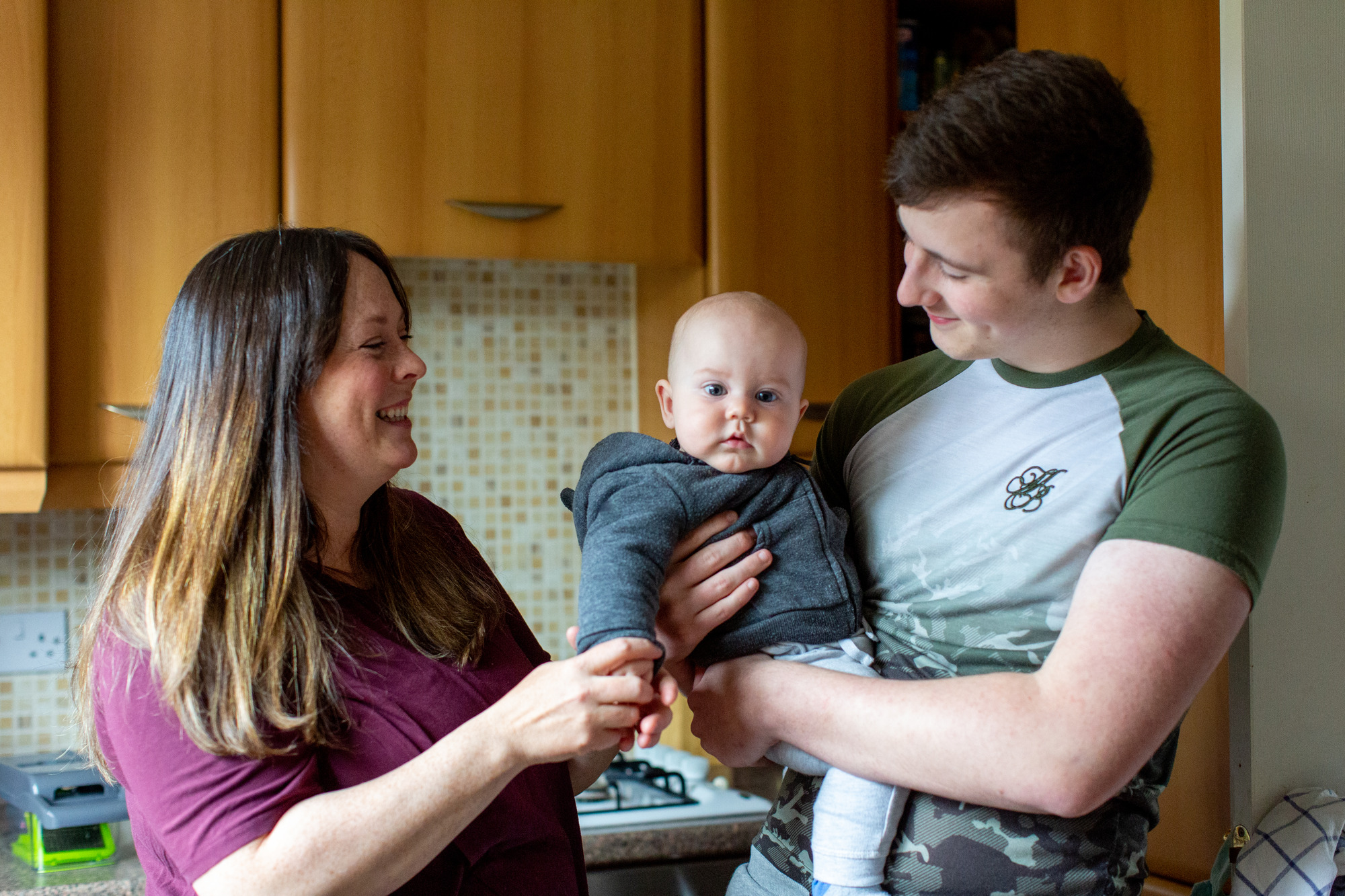 young couple holding small baby